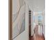 Bright hallway with hardwood flooring, accented by modern art and leading to a bedroom with city views at 2777 Paradise Rd # 1105, Las Vegas, NV 89109