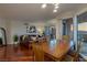 Open living area features a dining table, modern chandelier, hardwood floors, and a cozy couch with city views at 2777 Paradise Rd # 1105, Las Vegas, NV 89109