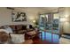 Elegant living room featuring hardwood floors, a comfy leather sofa, and balcony access with city views at 2777 Paradise Rd # 1105, Las Vegas, NV 89109