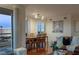 Spacious living room with hardwood flooring and open floor plan to dining room with floor to ceiling windows at 2777 Paradise Rd # 1105, Las Vegas, NV 89109