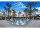 Serene community swimming pool surrounded by palm trees and shaded lounge areas with city views at 2777 Paradise Rd # 1105, Las Vegas, NV 89109