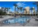 Inviting community swimming pool with sundeck surrounded by palm trees and shaded lounge areas at 2777 Paradise Rd # 1105, Las Vegas, NV 89109