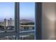 Relaxing view of the city buildings and distant mountains, seen through a large window with elegant curtains at 2777 Paradise Rd # 1105, Las Vegas, NV 89109