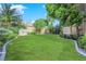 Landscaped backyard with grassy lawn and playhouse at 2891 Painted Lilly Dr, Las Vegas, NV 89135