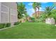 Landscaped backyard with grassy lawn and playhouse at 2891 Painted Lilly Dr, Las Vegas, NV 89135