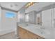 Bathroom with double vanity, light wood cabinets, and tiled floors at 2891 Painted Lilly Dr, Las Vegas, NV 89135