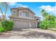 Two-story house with a three-car garage and landscaped yard at 2891 Painted Lilly Dr, Las Vegas, NV 89135