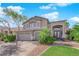 Two-story house with a three-car garage and landscaped yard at 2891 Painted Lilly Dr, Las Vegas, NV 89135