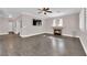 Living room featuring hardwood floors, fireplace and ceiling fan at 2891 Painted Lilly Dr, Las Vegas, NV 89135
