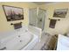 Bright bathroom with a shower, soaking tub, and neutral tile at 3254 Cactus Springs Dr, Laughlin, NV 89029