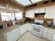 Well-lit kitchen featuring white appliances, a double sink, and plenty of counter space at 3254 Cactus Springs Dr, Laughlin, NV 89029