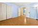 Light and airy bedroom with wood floors and access to a bathroom at 3360 Paso Andres St, Las Vegas, NV 89146