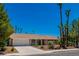 Single-story house with a white garage door and palm trees at 3360 Paso Andres St, Las Vegas, NV 89146