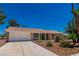 Ranch-style home with attached garage and landscaping at 3360 Paso Andres St, Las Vegas, NV 89146