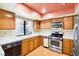 Kitchen features wood cabinets, stainless steel appliances and a pink ceiling at 3360 Paso Andres St, Las Vegas, NV 89146