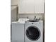Clean laundry room with washer and dryer and overhead cabinets at 3360 Paso Andres St, Las Vegas, NV 89146