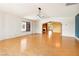 Bright living room with hardwood floors and an arched entryway at 3360 Paso Andres St, Las Vegas, NV 89146