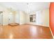 Living room with hardwood floors and an orange accent wall at 3360 Paso Andres St, Las Vegas, NV 89146