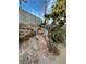 Backyard featuring a retaining wall and desert landscaping in need of cleanup at 3551 Rio Mayo Dr, Las Vegas, NV 89121