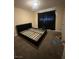 Bedroom featuring a black bed frame, dark curtains, and neutral carpet at 3551 Rio Mayo Dr, Las Vegas, NV 89121