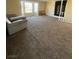 Spacious living room featuring neutral carpeting and large windows at 3551 Rio Mayo Dr, Las Vegas, NV 89121