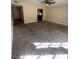 Bright living room featuring neutral carpeting, ceiling fan, and natural light at 3551 Rio Mayo Dr, Las Vegas, NV 89121