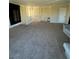 Spacious living room featuring neutral carpeting and plenty of natural light at 3551 Rio Mayo Dr, Las Vegas, NV 89121