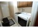 Functional laundry room with modern washer and dryer, tile floor and cabinet storage at 3905 E Cherokee Ave, Las Vegas, NV 89121