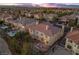 Aerial shot captures a two-story home with a spacious backyard, including a pool, seating area, and lush landscaping at 4439 Melrose Abbey Pl, Las Vegas, NV 89141