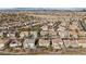 Wide aerial view of a residential neighborhood with varied home styles and desert landscapes in the background at 4439 Melrose Abbey Pl, Las Vegas, NV 89141