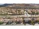 High angle aerial shot displaying the community's layout with homes arranged along orderly streets near a hillside development at 4439 Melrose Abbey Pl, Las Vegas, NV 89141