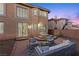 Inviting backyard with patio seating area, perfect for outdoor relaxation and entertaining with easy access to the home at 4439 Melrose Abbey Pl, Las Vegas, NV 89141