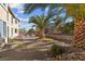 A large backyard features palm trees, a brick patio, and plenty of privacy at 4439 Melrose Abbey Pl, Las Vegas, NV 89141