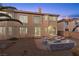 The backyard includes a patio with seating, surrounded by mature trees offering a private outdoor experience at 4439 Melrose Abbey Pl, Las Vegas, NV 89141