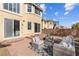 Backyard featuring a brick patio with outdoor furniture, a block wall, and an adjacent home at 4439 Melrose Abbey Pl, Las Vegas, NV 89141