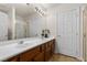 The bathroom features a double sink, vanity, large mirror with vanity lighting, shower with gold trim, and a separate water closet at 4439 Melrose Abbey Pl, Las Vegas, NV 89141