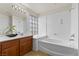 This bathroom features a shower over tub with glass block accent and a vanity with a vessel sink at 4439 Melrose Abbey Pl, Las Vegas, NV 89141