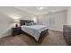 Bedroom featuring a bed with soft bedding, wood furnishings, bedside lamps, and a large window with shutters at 4439 Melrose Abbey Pl, Las Vegas, NV 89141