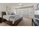 Bedroom featuring a large bed, ample natural light, and sleek furnishings at 4439 Melrose Abbey Pl, Las Vegas, NV 89141