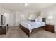 Cozy bedroom boasts a comfortable bed with soft, neutral bedding, a nightstand, and a mounted television at 4439 Melrose Abbey Pl, Las Vegas, NV 89141
