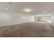 This spacious bonus room features a slider door that lets in lots of natural light and plush carpet at 4439 Melrose Abbey Pl, Las Vegas, NV 89141