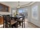 Bright dining area with sliding door, modern furnishings, and contemporary lighting fixture at 4439 Melrose Abbey Pl, Las Vegas, NV 89141
