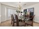 Elegant dining room featuring a glass table, a chandelier, and stylish decor at 4439 Melrose Abbey Pl, Las Vegas, NV 89141