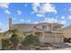 Beautiful two-story home with a tile roof, a well-manicured lawn, mature trees, and an attached three-car garage at 4439 Melrose Abbey Pl, Las Vegas, NV 89141