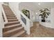 Inviting foyer features tile flooring, staircase, and ample natural light at 4439 Melrose Abbey Pl, Las Vegas, NV 89141