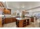 Cozy kitchen features a central island, granite counters, and stainless steel appliances at 4439 Melrose Abbey Pl, Las Vegas, NV 89141