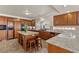 Well-equipped kitchen with granite countertops, a central island, and wooden cabinets at 4439 Melrose Abbey Pl, Las Vegas, NV 89141