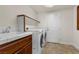 The laundry room has a sink and newer front-loading washer and dryer plus a storage shelf at 4439 Melrose Abbey Pl, Las Vegas, NV 89141