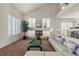 Bright living room featuring high ceilings, a fireplace, and plantation shutters for optimal natural light at 4439 Melrose Abbey Pl, Las Vegas, NV 89141