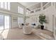 Bright living room features plantation shutters, high ceilings, and a sliding glass door at 4439 Melrose Abbey Pl, Las Vegas, NV 89141